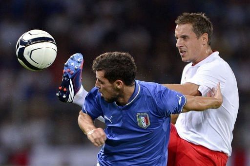 England's defender Phil Jagielka (R) vies for the ball with Italy's forward Mattia Destro